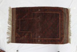 A Belouch style prayer rug with a central geometric panel,