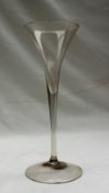 A 19th century wine glass with a wide tapering bowl, plain tapering stem and arched spreading foot,