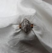 A diamond cluster ring of pointed oval form set with round brilliant cut diamonds to a 9ct yellow