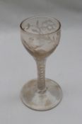 An 18th century dram glass, with rounded bowl embellished with etched vines and bird decoration,