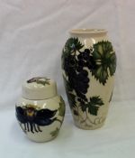 A Moorcroft pottery vase decorated with grapes and leaves to a cream ground,