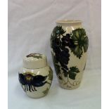 A Moorcroft pottery vase decorated with grapes and leaves to a cream ground,