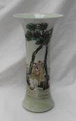 A Chinese porcelain trumpet vase, painted with figures under a tree,