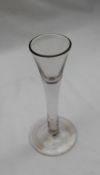 An 18th century wine glass with a tapering bowl, plain drawn stem and spreading foot, 17.
