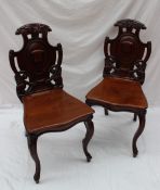 A pair of Victorian mahogany hall chairs, with a shield shape back,