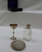 An Edwardian silver travelling communion set, with chalice, patten and silver topped bottle, cased,