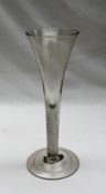 An 18th century ale glass with a flared tapering bowl and air twist drawn stem on a fold over foot
