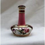 A 19th century English porcelain scent bottle with a tapering neck in a pink glaze,