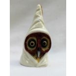 A Worcester candlesnuffer in the form of an owl in a hood, puce mark,