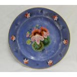 A porcelain plate, with a light blue ground, painted to the centre with flowers and leaves,