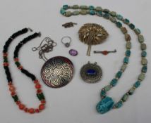 Assorted costume jewellery including a bead necklace, scarab carved necklace,