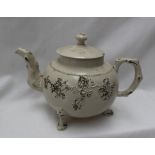 An 18th century English saltglazed teapot, decorated with moulded flower heads and leaves,