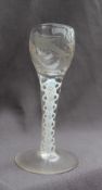An 18th century wine glass, with rounded bowl embellished with etched vine and bird decoration,