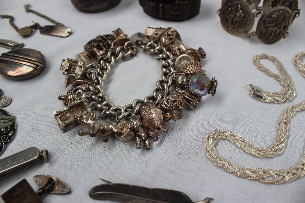 A silver charm bracelet set with a large number of silver charms including a church, bell, harp, - Image 3 of 4