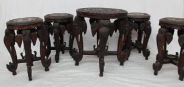 An Indian carved teak occasional table, the oval top carved with camels, elephants,
