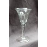A large wine glass with a trumpet shaped bowl on a tear drop drawn stem and spreading foot with