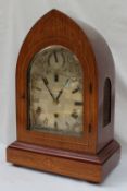 A Regency style mahogany bracket clock, of pointed arched form, with stringing decoration,