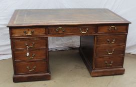 A Victorian style mahogany pedestal desk with a rectangular leather inset top above three drawers,