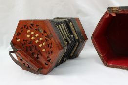 A Lachenal and Co. concertina, with pierced mahogany ends and steel reeds, No.