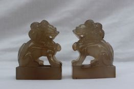 A pair of Chinese hardstone dogs of foo, in a seated position on rectangular plinths, 7cm high x 5.