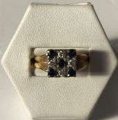 A sapphire and diamond ring of square form set with five sapphires and four diamonds to a white