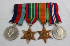 A set of four World War II medals including The Defence Medal, The War Medal,
