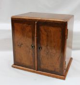 A late 19th century walnut table top cabinet of rectangular form with a pair of cupboard doors