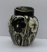 A Moorcroft pottery ginger jar and cover, decorated in the harlequinade pattern,
