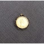 An Elizabeth II gold sovereign dated 1974, in a 9ct yellow gold slip mount,