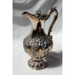 A William IV Scottish silver baluster hot water pot decorated with swags, leaves and flowers,