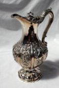 A William IV Scottish silver baluster hot water pot decorated with swags, leaves and flowers,