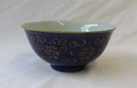 A 19th century Chinese porcelain bowl with a blue ground and gilt highlighted decoration,