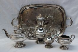 An Electroplated four piece tea service decorated with scrolling leaves together with an