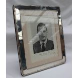 A modern silver photograph frame, of rectangular form, with a line decorated border, 30 x 25cm,