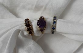 A three stone amethyst ring set to a 9ct yellow gold shank together with a five stone garnet ring