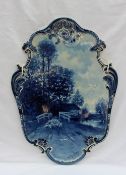 A Joost Thooft & Labouchere Delft pottery plaque of oval form cast with a shell and scrolls,
