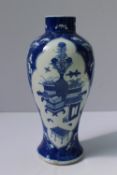 A Chinese porcelain inverted baluster vase painted with two vignettes of vases and flowers to a