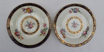 A pair of 19th century porcelain plates painted with sprays of garden flowers,