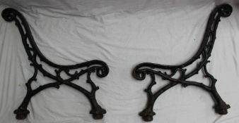 A cast iron garden bench the ends cast in the form of gnarled branches