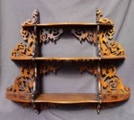 A Victorian walnut hanging shelf, with three graduated shaped shelves,