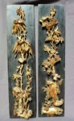 A pair of carved oriental gilt decorated panels, depicting birds amongst foliage to a black ground,