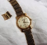 A Gentleman's 9ct yellow gold Longines wristwatch, the silvered dial with Arabic numerals,