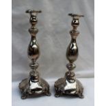 A pair of white metal Shabbat candlesticks,