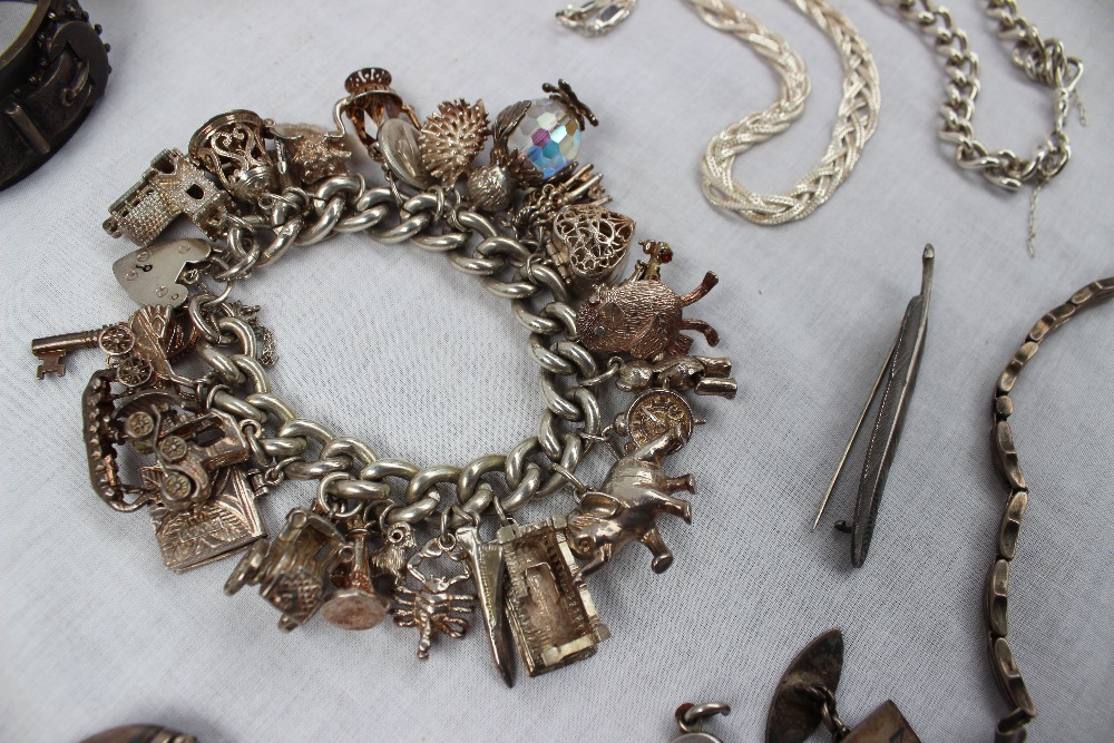 A silver charm bracelet set with a large number of silver charms including a church, bell, harp, - Image 4 of 4