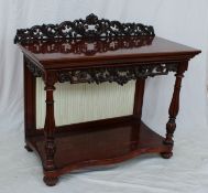 A Victorian mahogany buffet, with a carved back and apron,