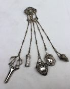 A late Victorian silver chatelaine, Birmingham, 1899, Henry Matthews with pierced floral decoration,
