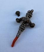 A late Victorian silver babies rattle, with coral teether, whistle and bells,