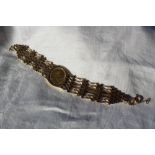 A 9ct yellow gold gate bracelet slip mounted with an Edward VII gold sovereign dated 1904,