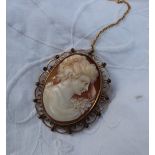 A shell cameo brooch depicting a lady in profile to a 9ct yellow gold setting