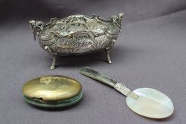 A continental white metal bowl, of oval form with winged cherub handles,